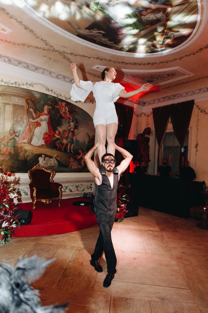 Aerial adagio performers working beneath the frescoed dome of Palácio do Grilo